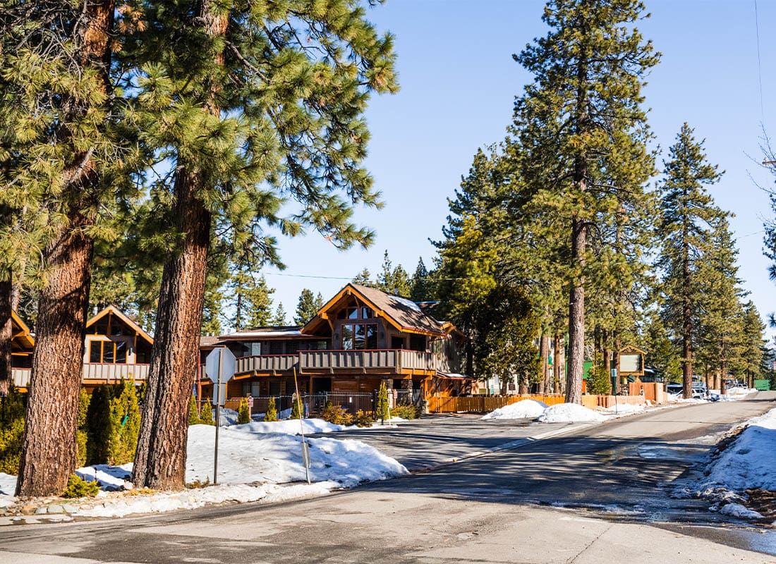 South Lake Tahoe, CA - Paved Street in South Lake Tahoe on a Sunny Winter Day, Snow Covering the Sidewalks